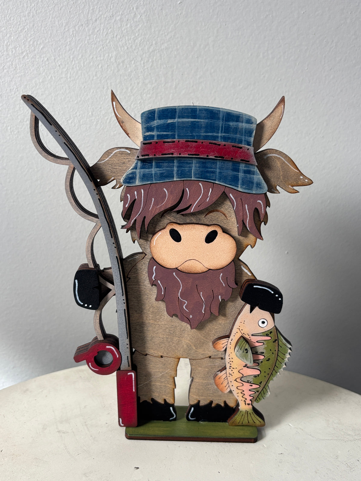 Camping and fishing standing highland cow